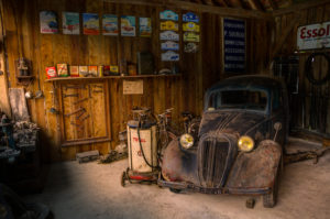 wooden garage with old black car