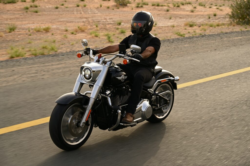 man in black riding a motorcycle